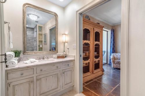 a bathroom with a sink and a mirror at Phoenix Vll 1401 in Orange Beach