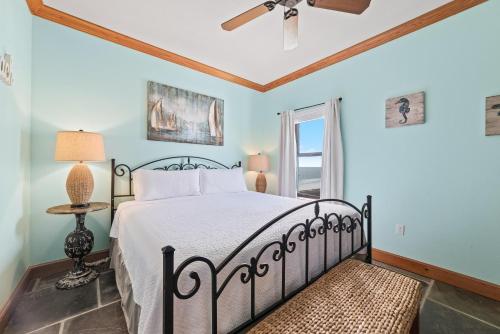 a bedroom with a bed and a ceiling fan at Phoenix Vll 1401 in Orange Beach