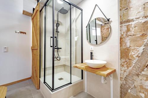 a bathroom with a glass shower and a sink at Trinitarios Apartment in Toledo