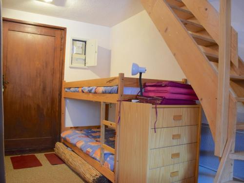 a bedroom with bunk beds and a staircase at Studio Bernex, 1 pièce, 4 personnes - FR-1-498-36 in Bernex