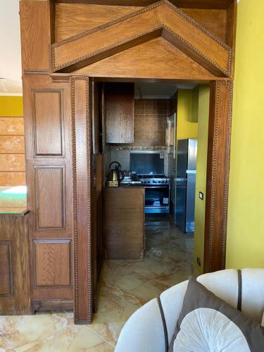 a kitchen with an open door to a kitchen with a refrigerator at Al Crown in Sharm El Sheikh