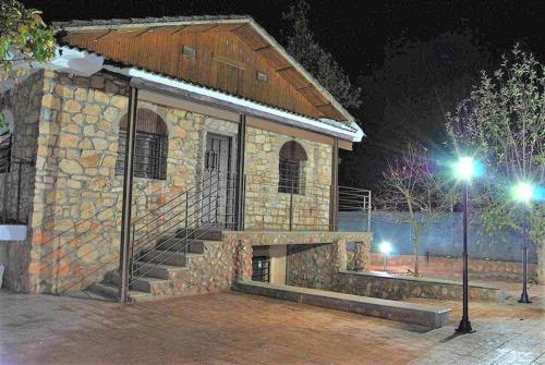 a stone building with a staircase in front at night at Casa Rural Villa Sem Sem in Ossa de Montiel