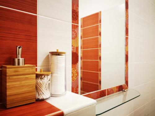 a bathroom with a glass shelf with a roll of toilet paper at Floral Apartment - NEW in town in Budapest