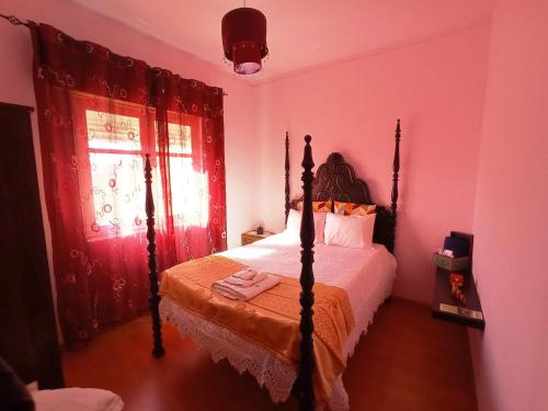 a bedroom with a bed in a pink room at Stunning House in Mirandela ideal for 10 people in Mirandela