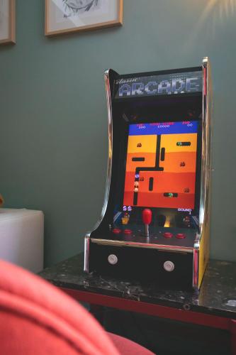 a video game machine sitting on top of a table at Le Central Boutique Hôtel in Beaune