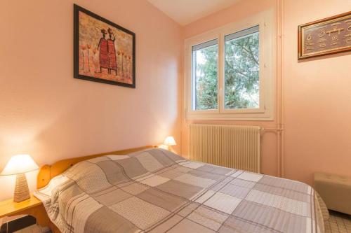 a bedroom with a bed and a window at La Combe des Paces in Châtillon-sur-Seine