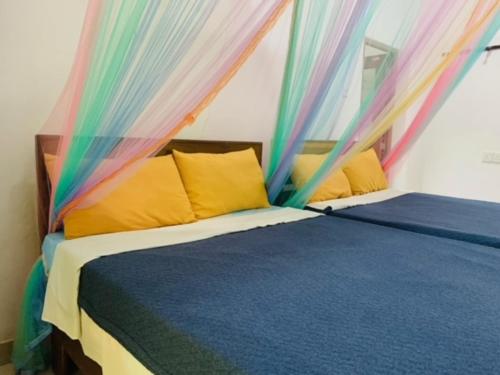 a bedroom with a bed with a colorful canopy at Quiet Rest Inn in Ella