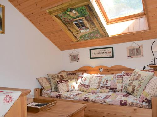 a bedroom with a bed with pillows and a window at Appartement Bernex, 2 pièces, 6 personnes - FR-1-498-31 in Bernex