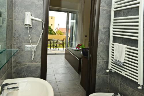 a bathroom with a sink and a toilet and a balcony at Villa Le Logge in Ventimiglia