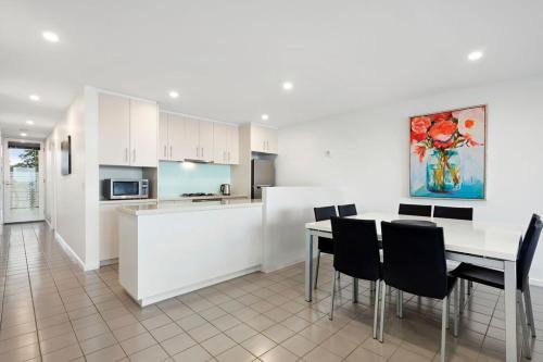 a kitchen and dining room with a table and chairs at Rip n View in Point Lonsdale