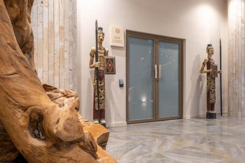 two statues of men in a room with a museum at Cádiz Bahía by QHotels in Cádiz
