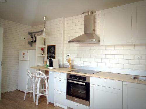 a kitchen with white cabinets and a stove top oven at Amplio, luminoso, moderno in Calasparra
