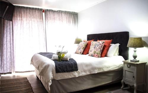 a bedroom with a large bed and a window at Kroon Manor in Kroonstad