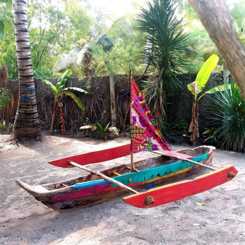 a group of boats sitting on the sand at Mpole Bungalows in Michamvi