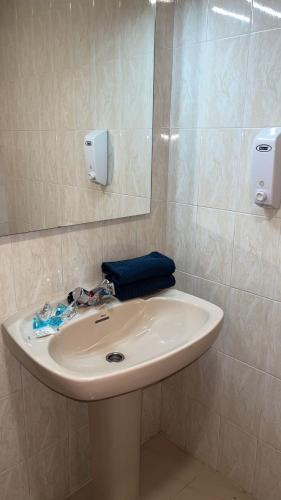a white sink in a bathroom with a mirror at El Canfranero in Canfranc-Estación
