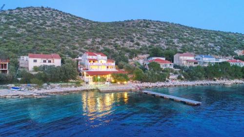 a resort on the shore of a body of water at Seafront Apartments Anthony in Lastovo