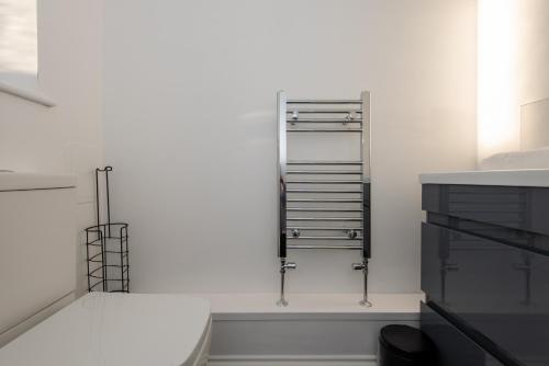 a bathroom with white walls and a shelf at 61 Deneside in Lanchester