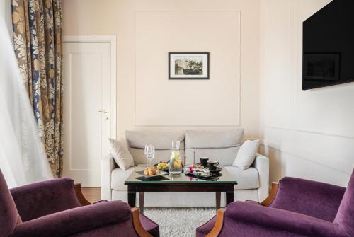 a living room with a couch and a table at Hotel Park Split in Split