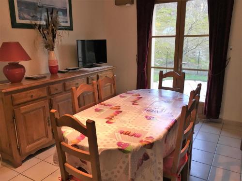 a dining room table with a table cloth on it at Villa de Plain-Pied avec Jardin Clos, Proche Plage et Commerces, Animaux Admis - FR-1-482-43 in Fort-Mahon-Plage
