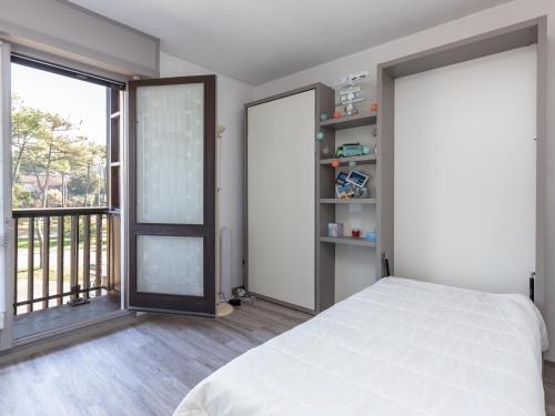 a bedroom with a bed and a large window at Appartement Seignosse, 3 pièces, 5 personnes - FR-1-239-448 in Seignosse