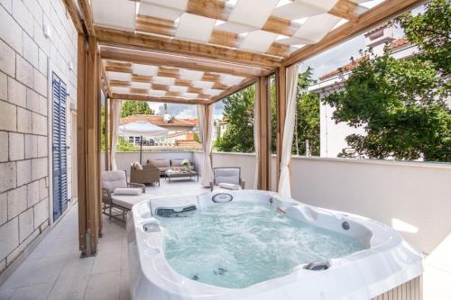 a hot tub on the patio of a house at Hotel Park Split in Split