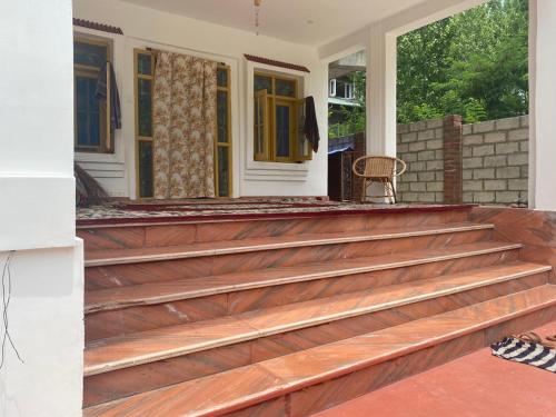 a porch with wooden steps to a house at Himalayan Breeze Homestay in Srinagar