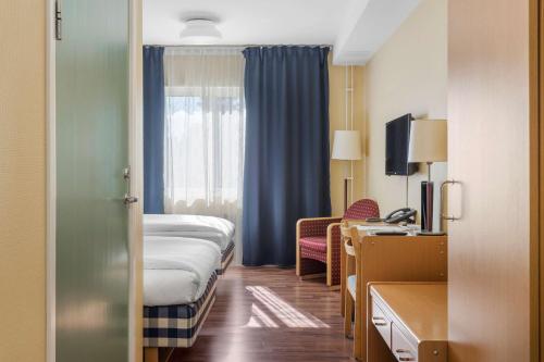 a hospital room with a bed and a window at Hotell Frykenstrand; Sure Hotel Collection by Best Western in Sunne