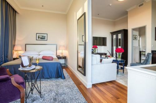 a bedroom with a bed and a living room at Hotel Park Split in Split