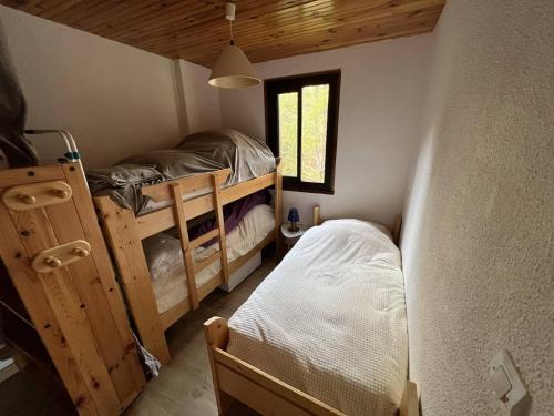 a bedroom with two bunk beds and a window at Studio Les Angles, 2 pièces, 5 personnes - FR-1-593-83 in Les Angles