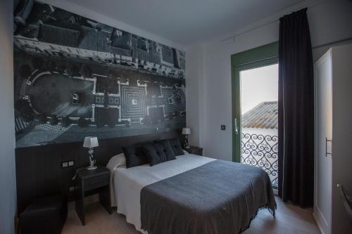 レブリハにあるHotel Barrio Nuevoのベッドルーム1室(ベッド1台、大きな窓付)