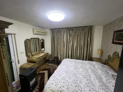 a bedroom with a bed and a television in it at Apartment in Shmaisani in Amman