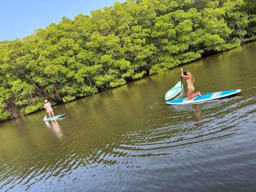 two people are on surfboards in the water at OHEI in Tangalle