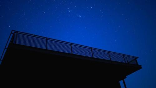 a building under a night sky with stars at Life At REPOSE- Lake Villas Resort & Club in Chor Warodra