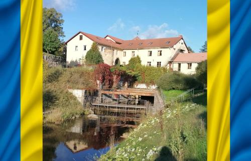 a house and a bridge over a river at Bille in Bille