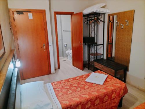a hotel room with a bed and a bathroom at Hotel MM Dateo in Milan