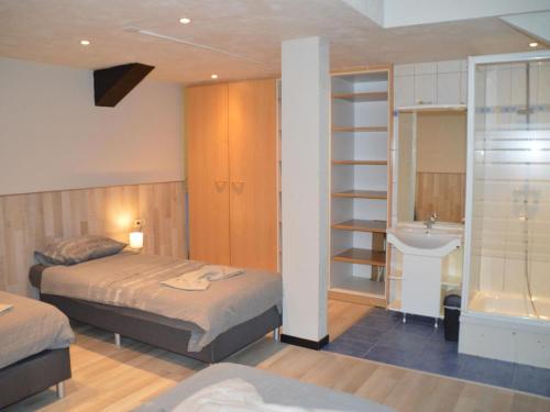 een slaapkamer met 2 bedden en een wastafel bij Vacation home in Verviers with private indoor pool in Verviers