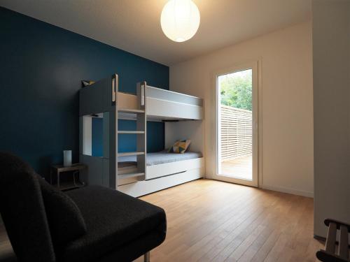 Cette chambre dispose de lits superposés, d'une chaise et d'une fenêtre. dans l'établissement Bel Appartement Proche Centre Ville avec Terrasse et Parking pour 6 Personnes à Arcachon - FR-1-474-63, à Arcachon
