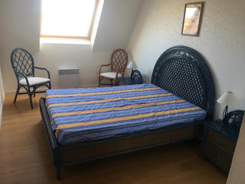 sypialnia z łóżkiem z 2 krzesłami i oknem w obiekcie Appartement Fort-Mahon-Plage, 3 pièces, 4 personnes - FR-1-482-5 w mieście Fort-Mahon-Plage