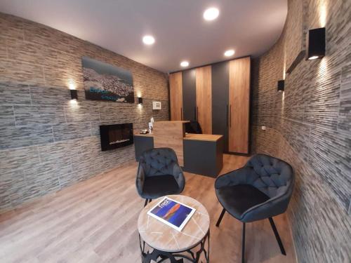 a waiting room with two chairs and a table at Blue View Apartments in Kavala