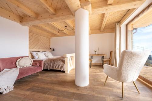 a room with a bed and a table and chairs at Dom Tatrzański Ewa Deluxe in Kościelisko