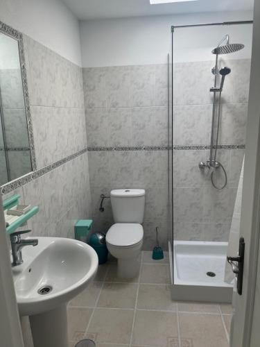 a bathroom with a toilet and a sink and a shower at La Arena VII in Los Abrigos