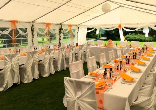 a row of tables and chairs in a tent at Pension Habermannova Vila in Bludov
