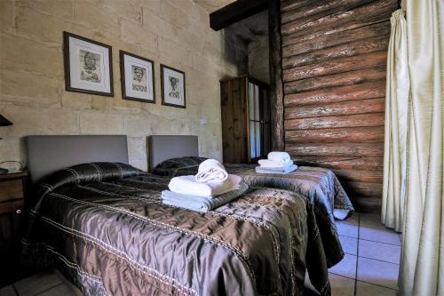 a bedroom with two beds with towels on them at Ta'Filomena in Xagħra