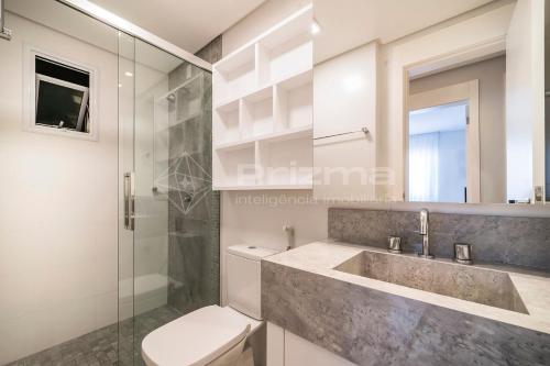 ein Bad mit einem Waschbecken, einem WC und einer Dusche in der Unterkunft Varandas 405 A · Apartamento em Condomínio de luxo frente ao mar . in Bombinhas