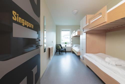 a room with two bunk beds and a door at Trondheim Vandrerhjem in Trondheim