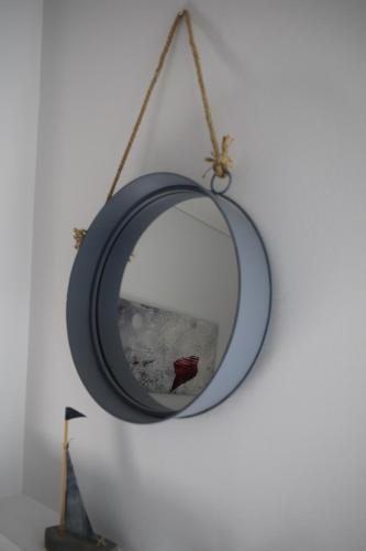 a mirror hanging on a wall at Comfort Stay Athens Airport Hotel - FREE shuttle from and to the airport in Spáta