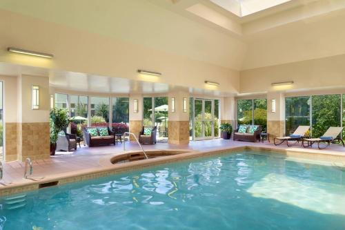 a swimming pool in a hotel lobby with a large pool at Atlanta Evergreen Lakeside Resort in Stone Mountain