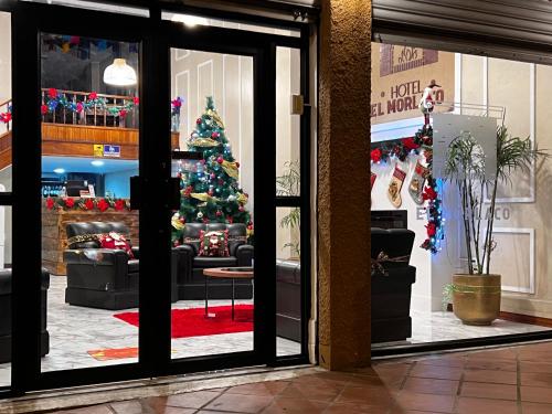 a christmas tree is seen through the window of a store at Hotel El Morlaco in Cuenca