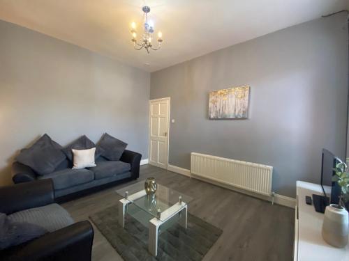 a living room with a couch and a table at Alexander Apartments Tyneside in Gateshead