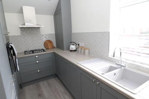 a kitchen with a sink and a counter top at The Hideout, IH4AOXF in Middlesbrough